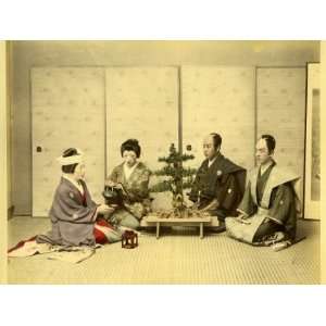 Japanese Men and Woman Seated on the Floor Take Tea in a Traditional 