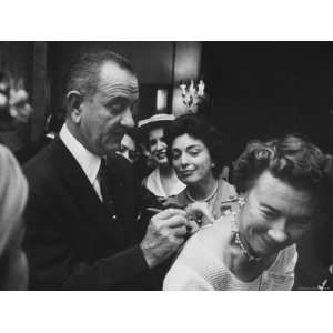 Lyndon B. Johnson Signing Card on Womans Back as Mrs. Burton Joseph 